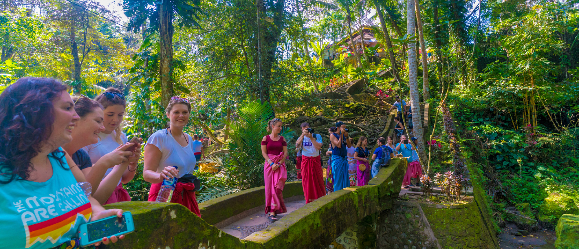 Group posing at the entrance to Goa Gajah (Elephant Cave) in Ubud