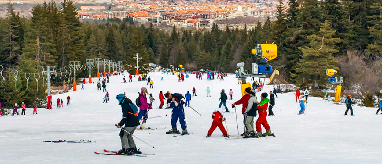 Skiers enjoying the sunny pistes above Bansko on day four