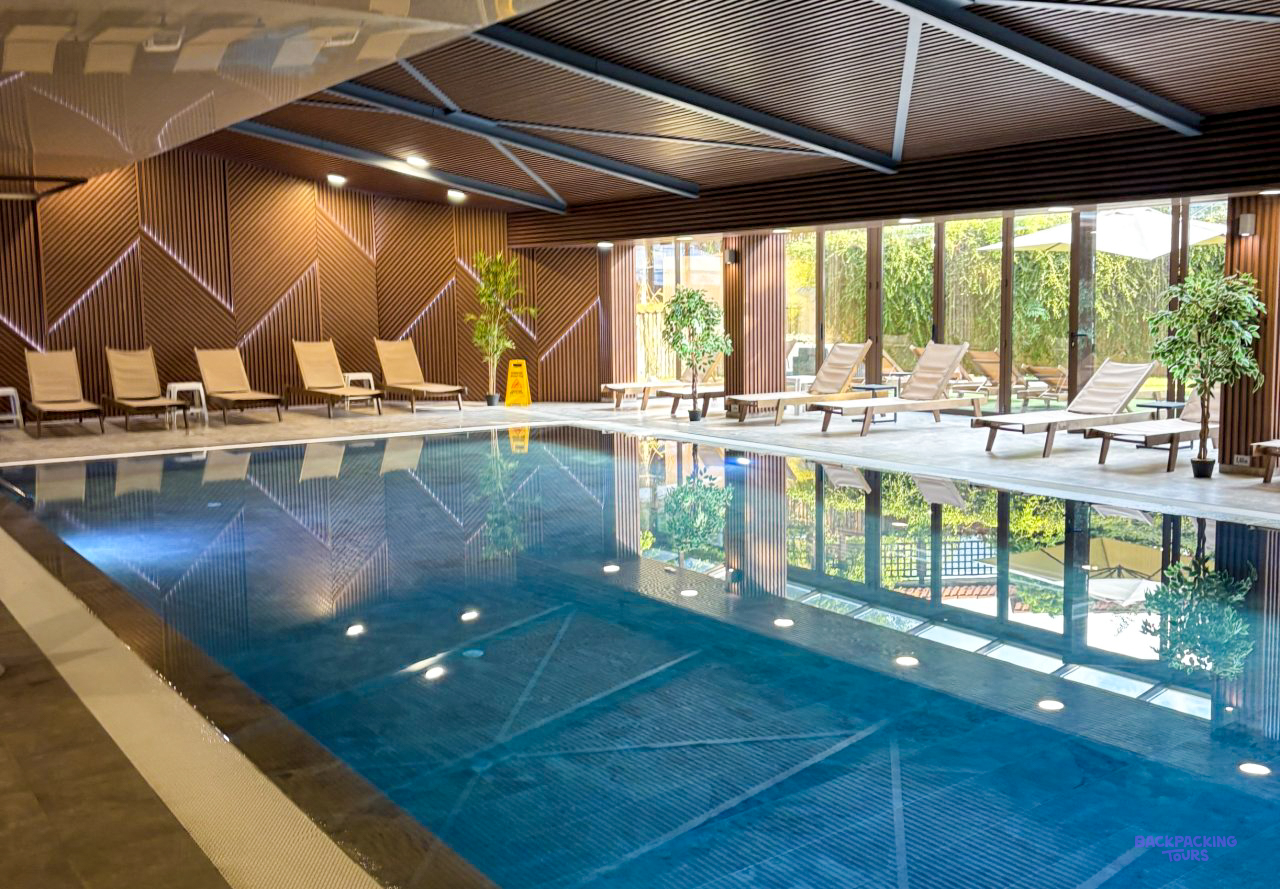 The indoor swimming pool with loungers at the hotel in Bansko