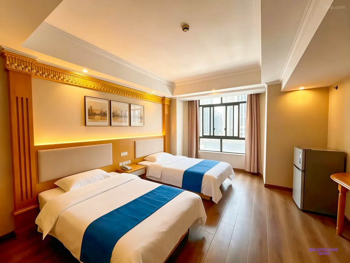A twin room with two single beds, blue runners, framed prints and a wooden floor.