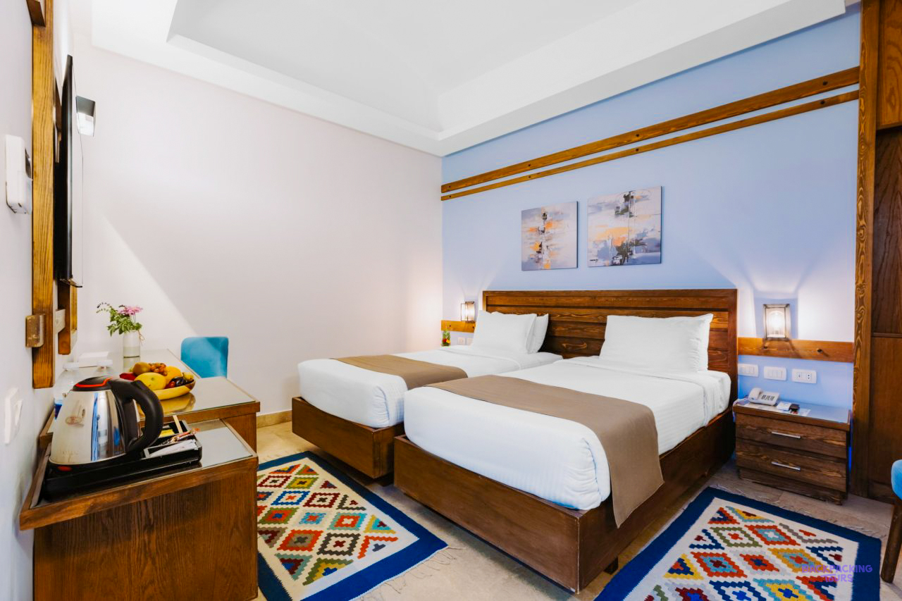 A twin room with patterned rugs at the hotel in Aswan