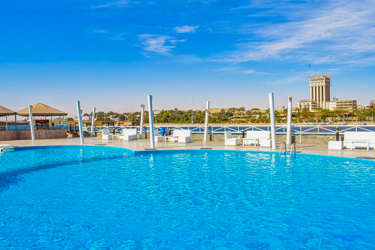 The swimming pool at the hotel in Aswan, with the Nile and the far bank behind