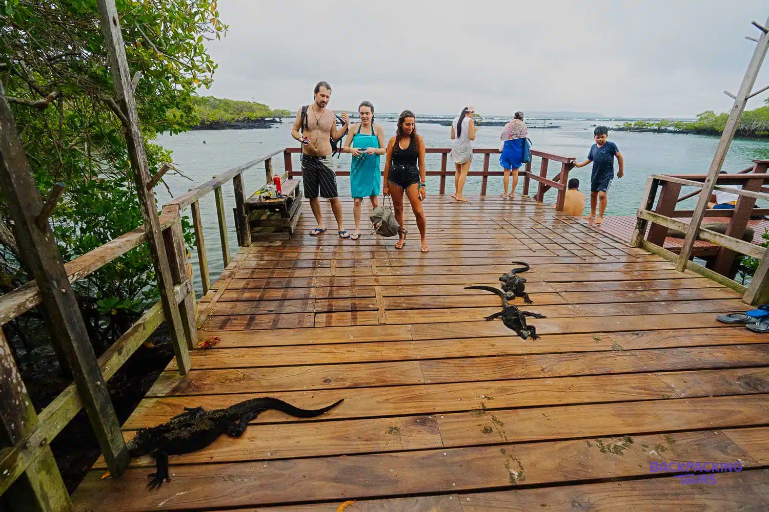 Travellers on the boardwalk to Concha Perla