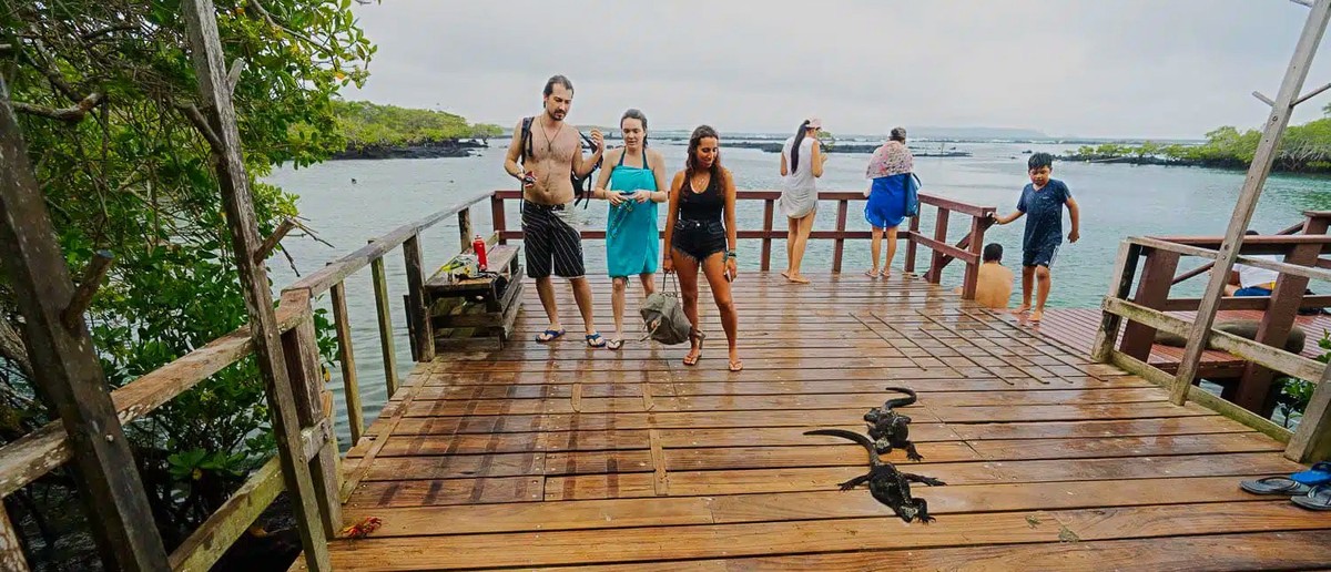 Travellers on the boardwalk to Concha Perla