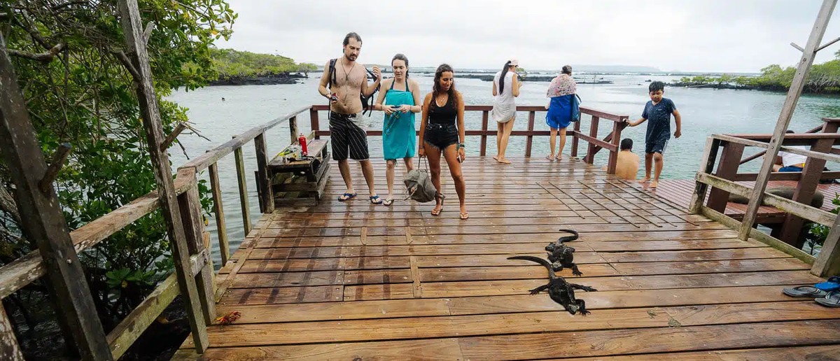 Travellers on the boardwalk to Concha Perla