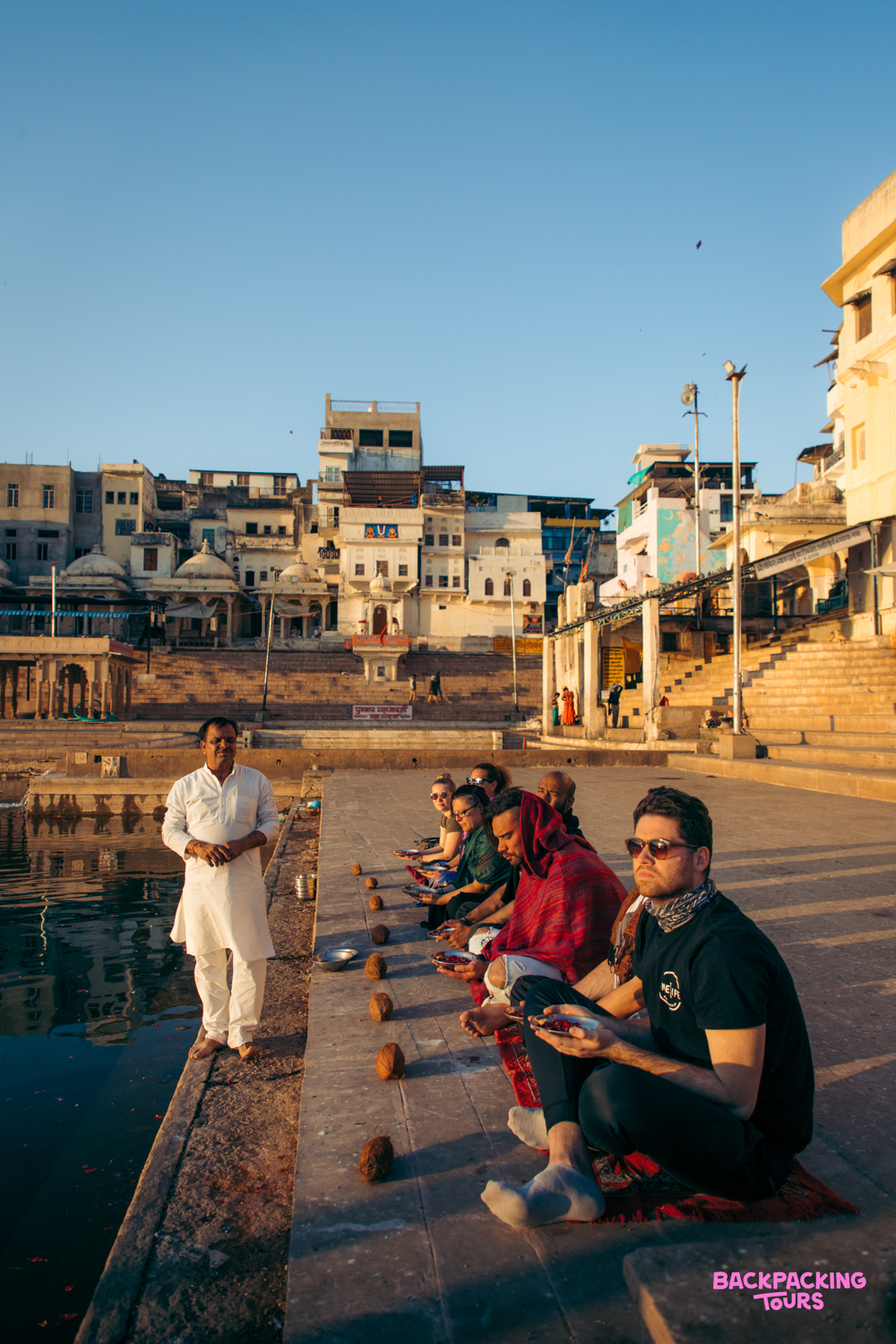 Backpackers receive a traditional Brahmin blessing by the sacred lake in Pushkar, India.