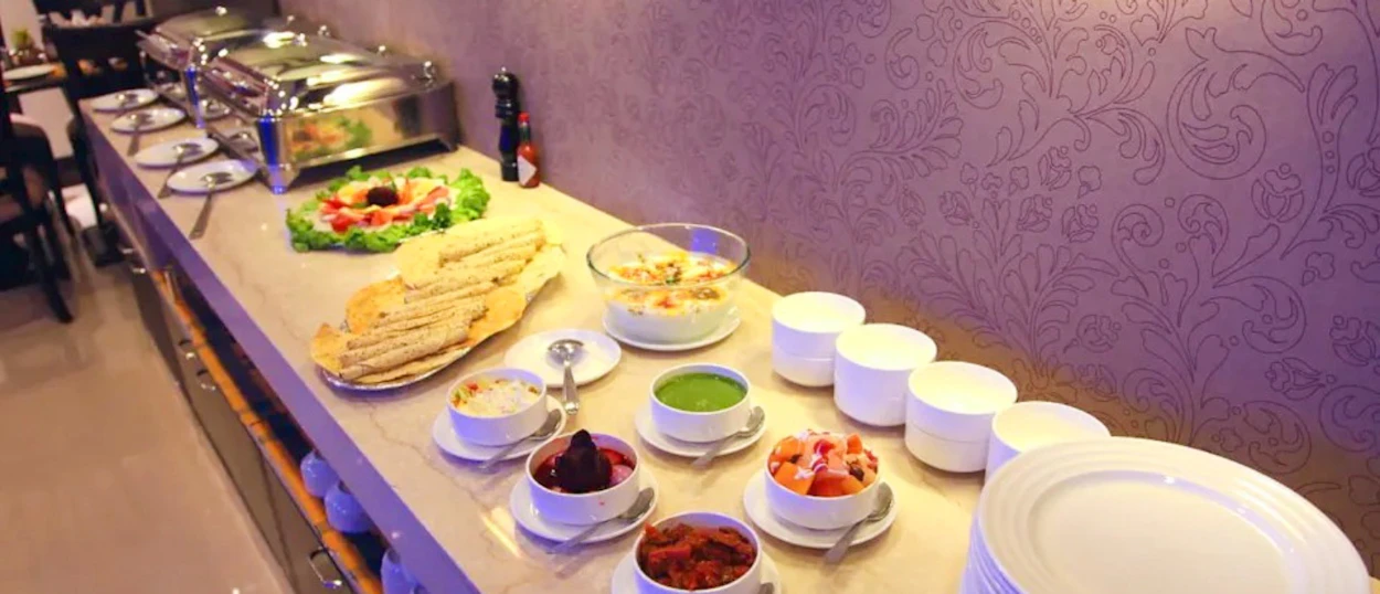 A delicious Indian buffet with flatbreads, salads, and hot dishes ready for a welcome dinner in New Delhi.