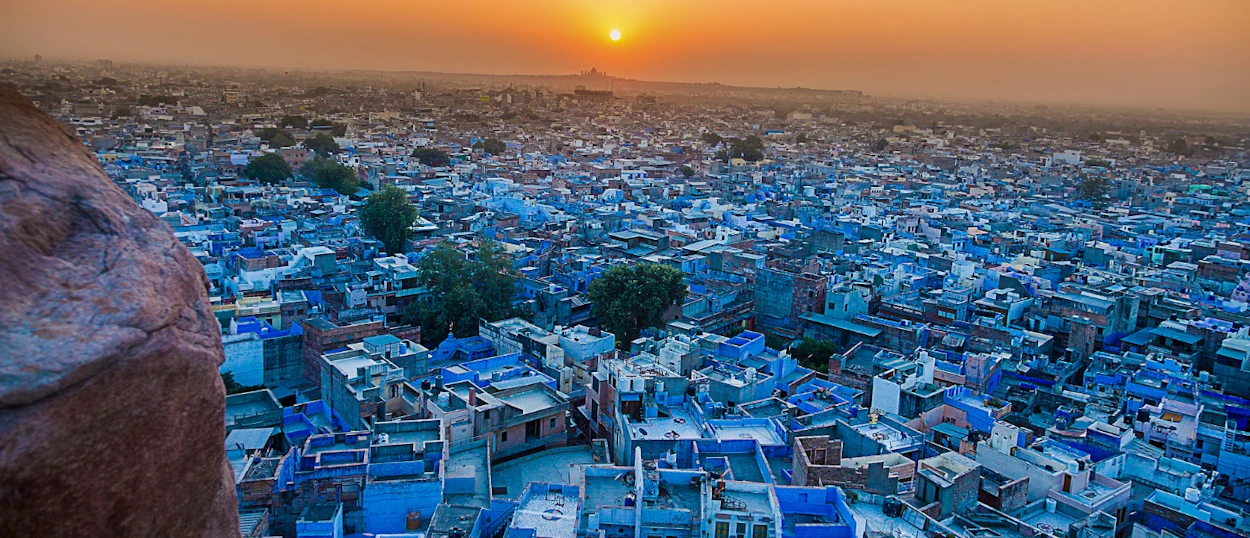 The enchanting blue city of Jodhpur at sunset, with countless blue buildings stretching to the horizon.