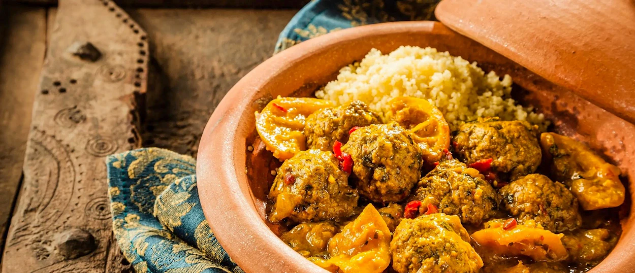 Authentic Moroccan tagine with meatballs and couscous, prepared during a cooking class in Imlil.
