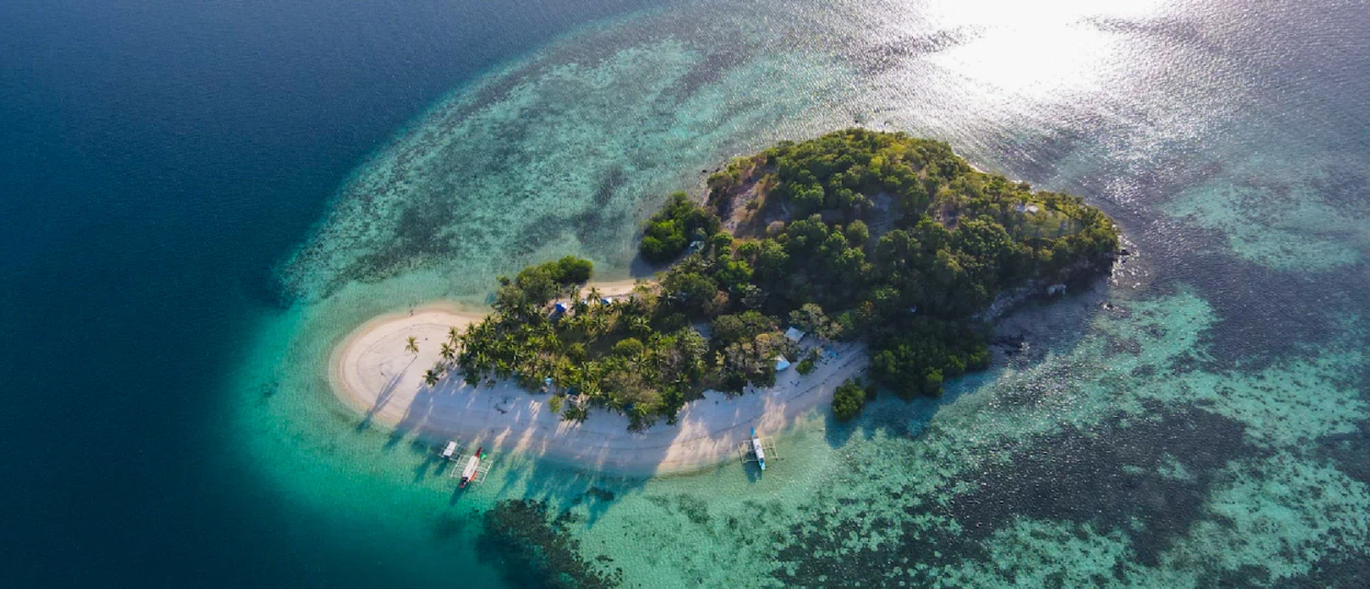 Aerial view of a tropical island with white sand beaches and clear turquoise waters, Coron, Philippines.