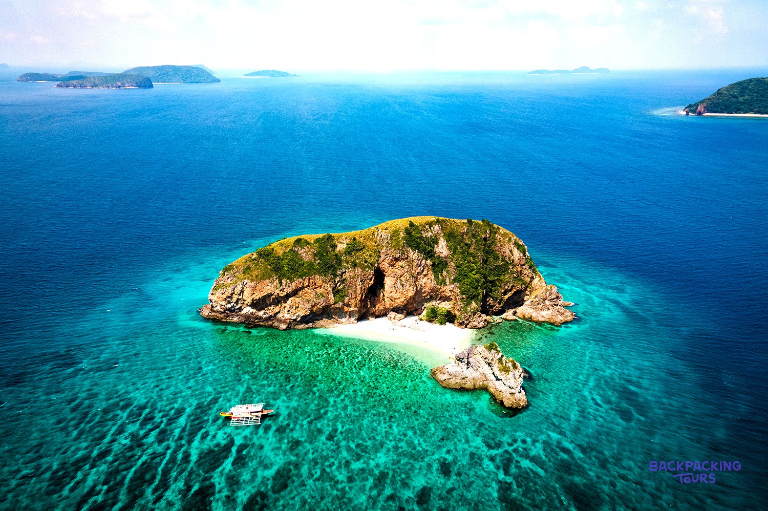 A traditional Banca boat anchored off a deserted island on the Coron to El Nido expedition.