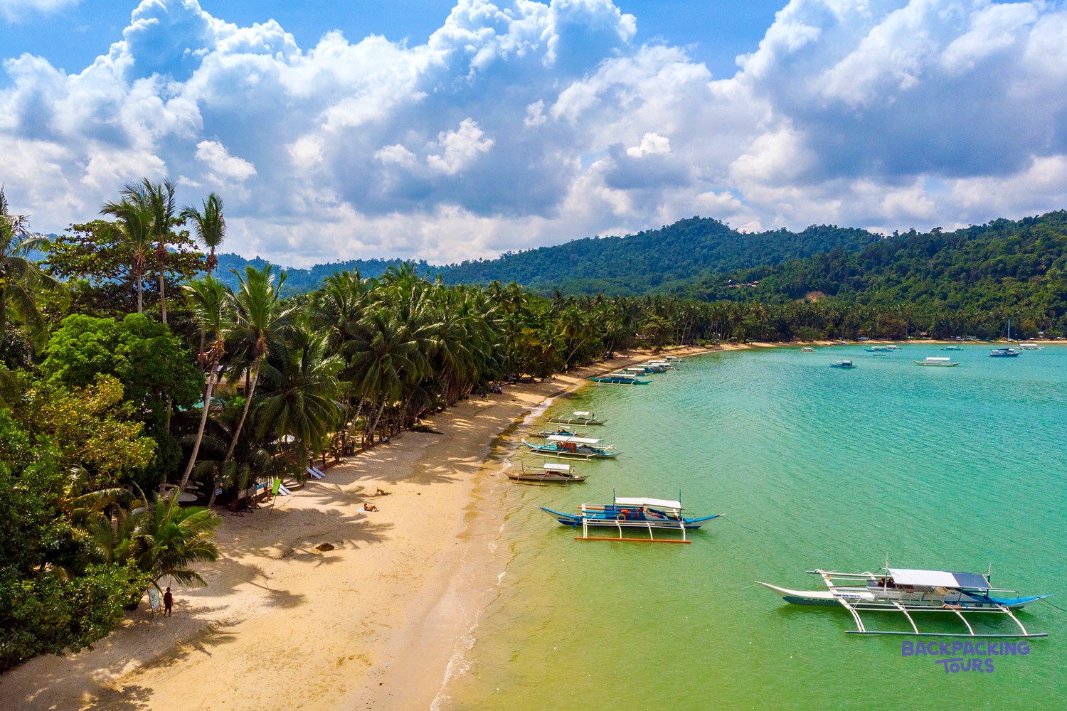 The quiet palm-lined beach at Port Barton in southern Palawan.