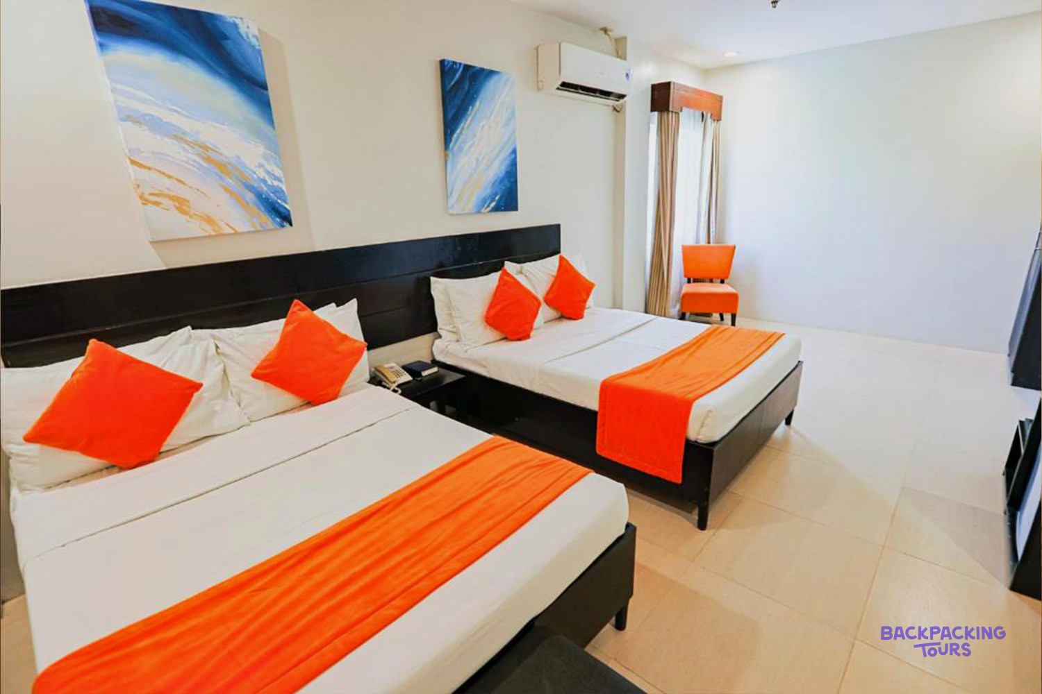 A modern twin room at Holiday Suites in Puerto Princesa.