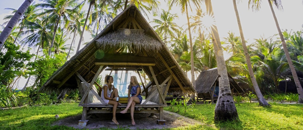 Simple traditional beach huts on a remote island used on the boat expedition.