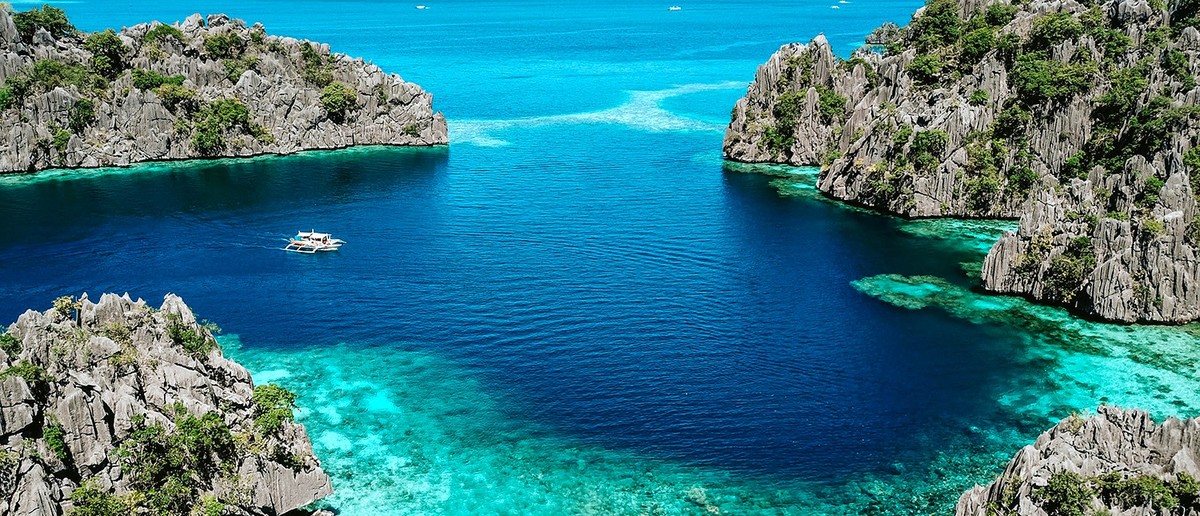 An aerial view of limestone karst islands and turquoise lagoons around Coron.