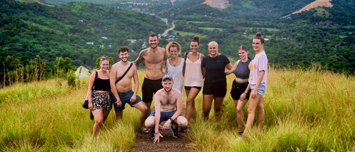 A group of backpackers celebrating at the Mount Tapyas viewpoint above Coron.