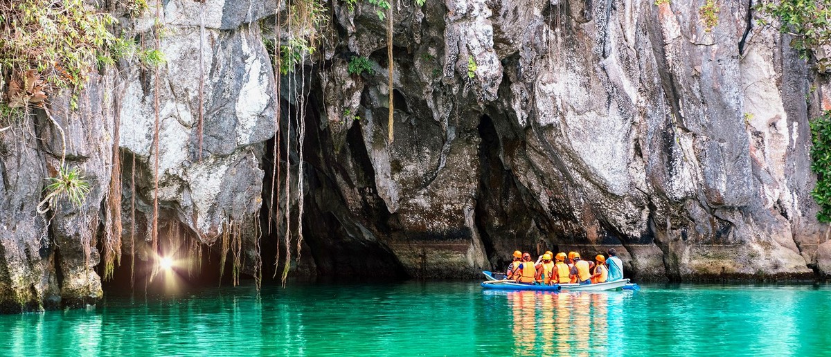 A boat entering the mouth of the Palawan Underground River cave system.