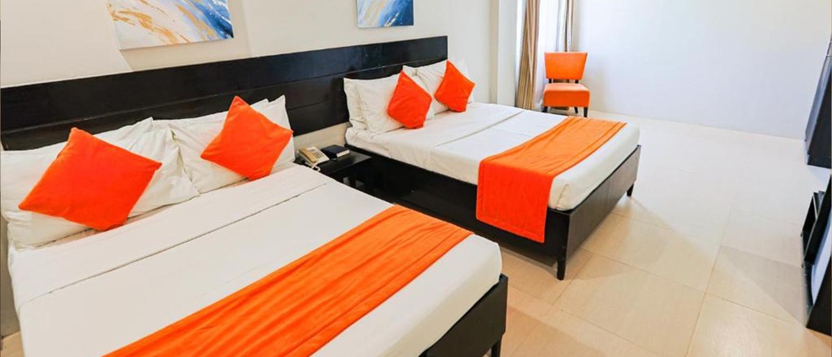 A modern twin room at Holiday Suites in Puerto Princesa.
