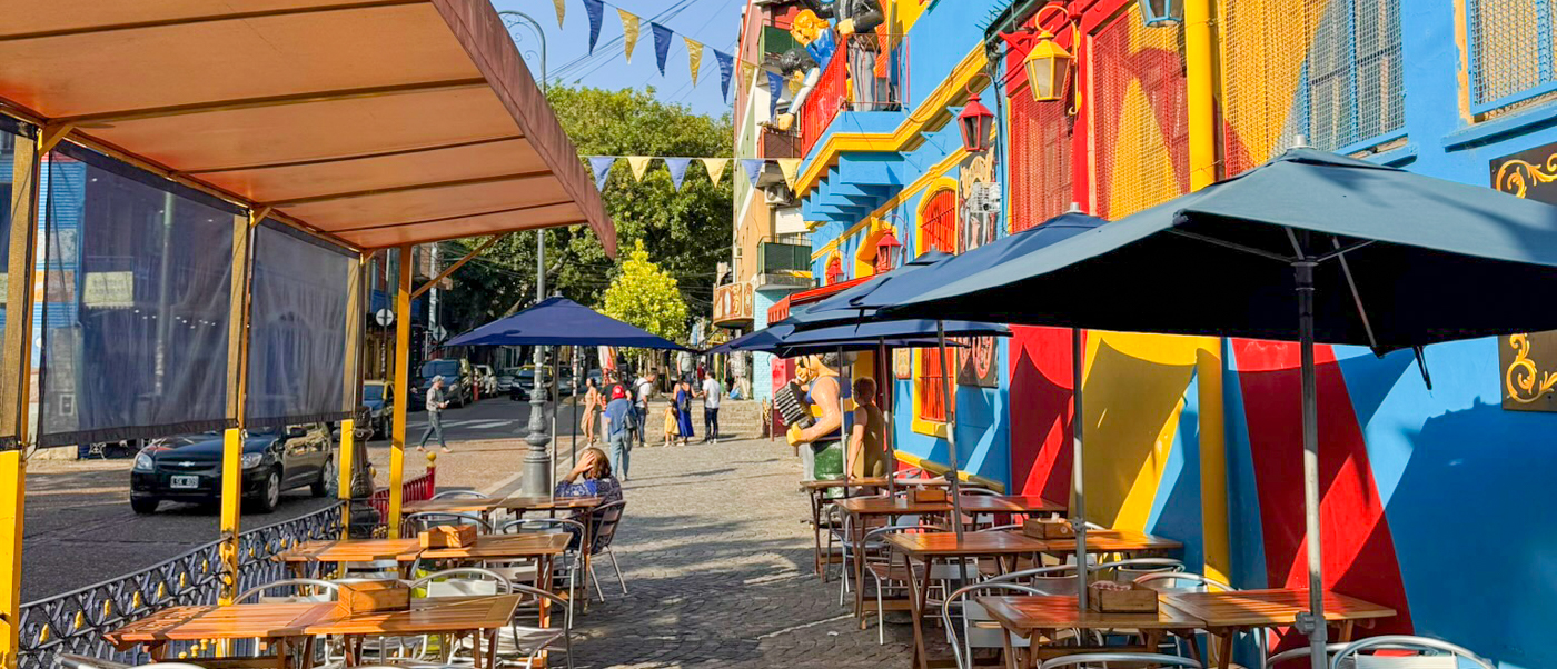 Brightly painted buildings and pavement cafes in La Boca, Buenos Aires