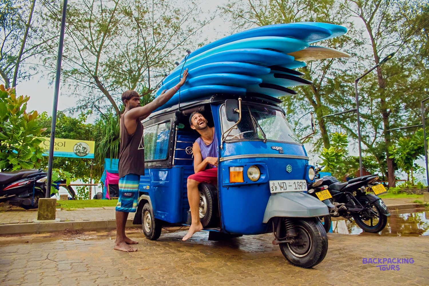 A tuk tuk loaded with surfboards in Mirissa