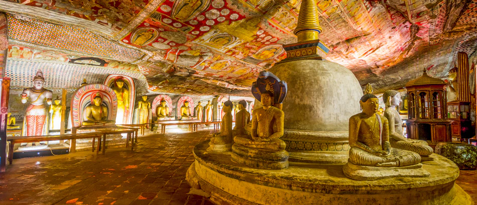 The ancient Dambulla Cave Temple in Sri Lanka, filled with many Buddha statues and vibrant frescoes.