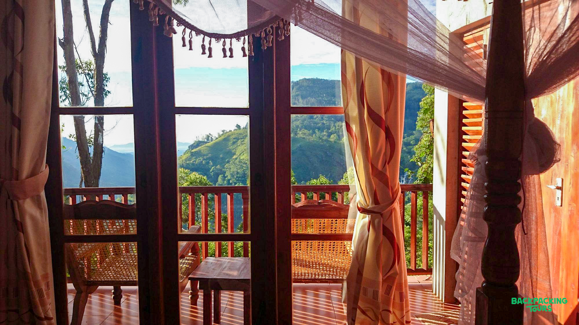 A serene balcony view overlooking the majestic green mountains and valleys of Ella.