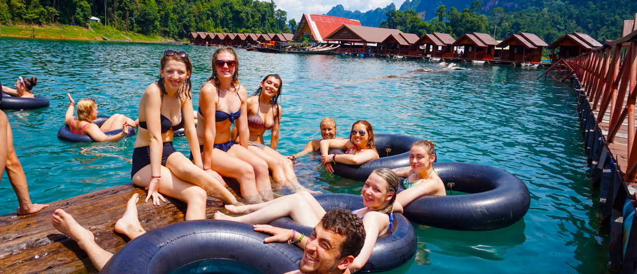 Backpacking tour group relaxing in floating bungalows with swimming pool at Khao SokX