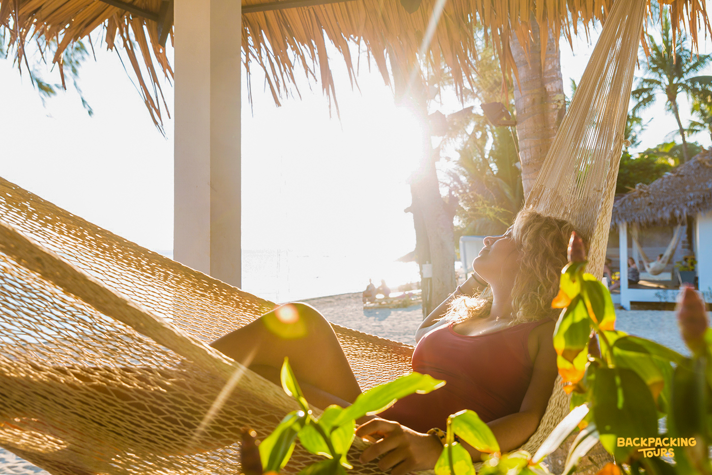 Hammock under palm trees on a tropical beach in Koh Phangan, perfect for relaxing after a day of exploration