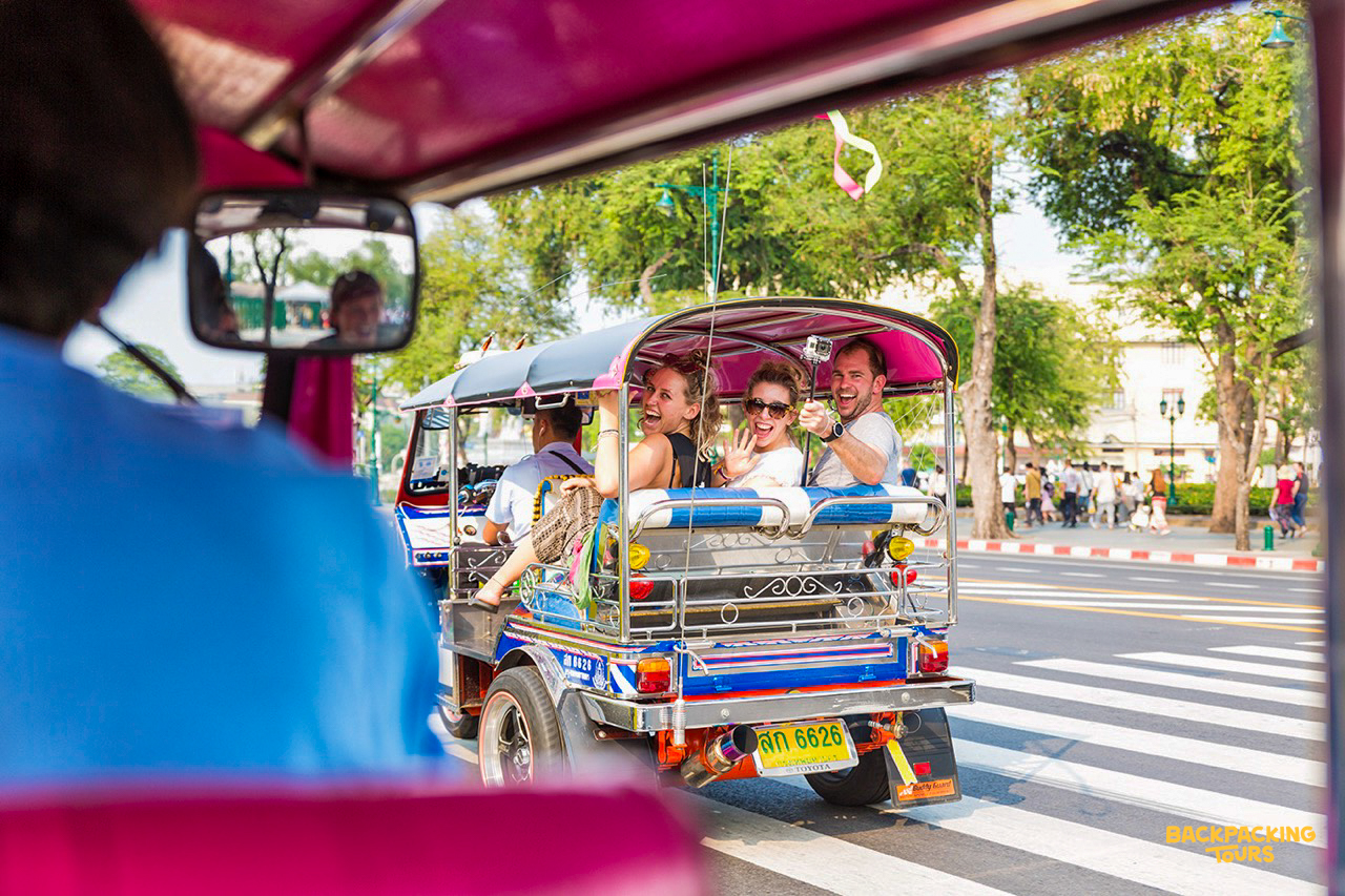 Colorful tuk-tuk ride through Bangkok streets during evening sightseeing tour