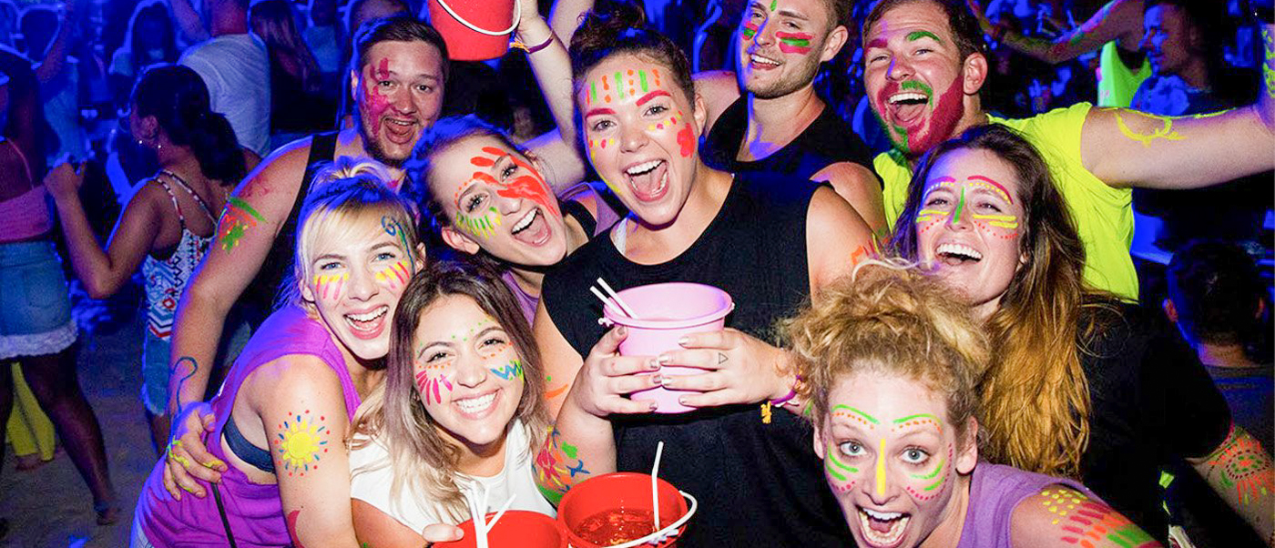 Backpacking group having fun at a lively beach party on Phi Phi Islands during the backpacking tour
