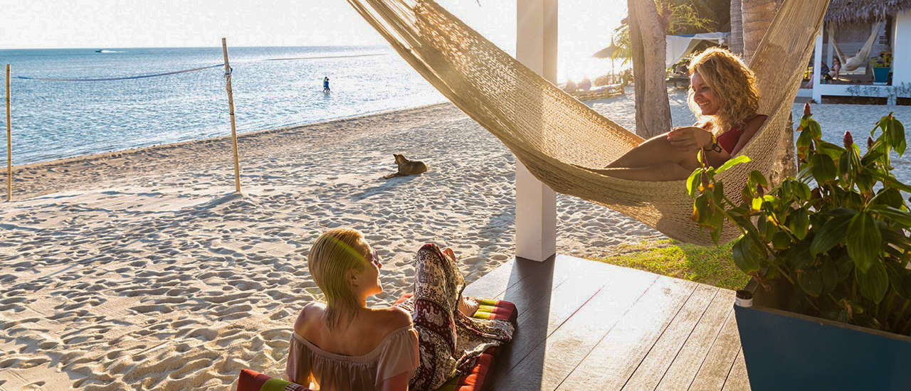 Backpacking group enjoying the beach view from Koh Phangan accommodation balcony